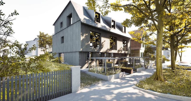 Modern two-story house with grey wooden facade, large windows, and a raised ground floor surrounded by trees and greenery.