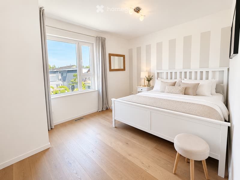 Modern bedroom with a white bed, nightstand, mirror, and a view through large windows.