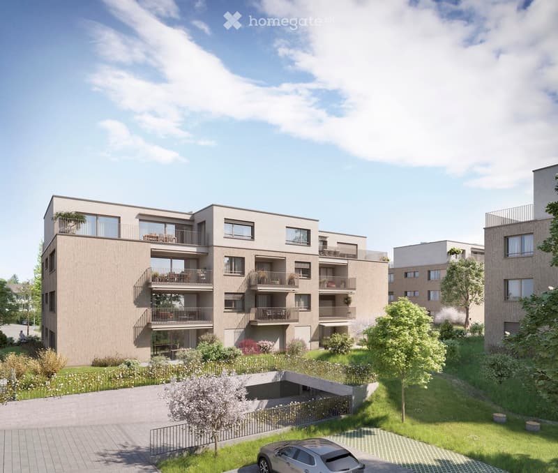 Modern multi-story residential building with balconies, surrounded by greenery and a parking area.