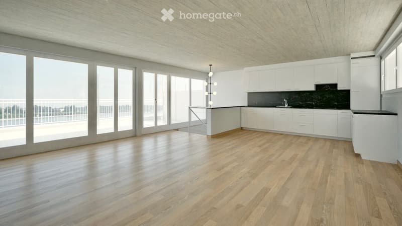 Modern, minimalist kitchen with white cabinets, a black countertop, and a sleek light fixture. The space features light wooden flooring and large windows with a view of a balcony.
