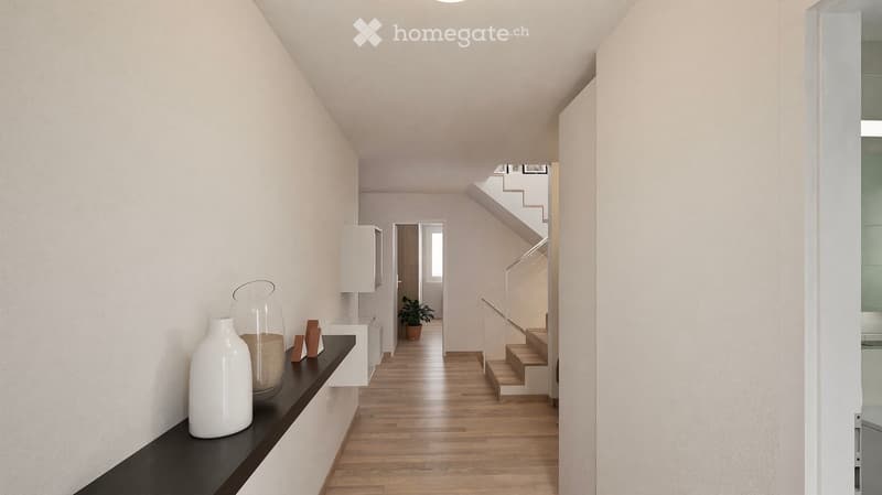 Modern hallway with wooden flooring, white walls, and a staircase leading upwards. Features a small black console table with decorative items, a potted plant, and a white cabinet.