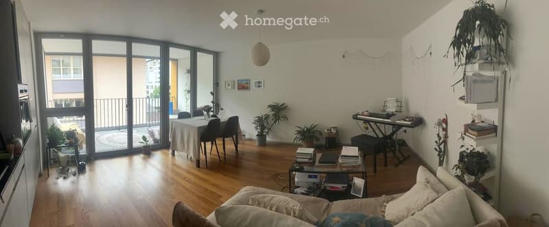 open living room, hardwood floor, couch, large windows, balcony