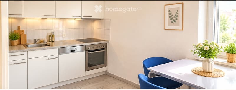 Modern kitchen with white cabinets, stainless steel appliances, a sink, and a small dining area with a table and chairs. There are potted plants and a framed picture on the wall.
