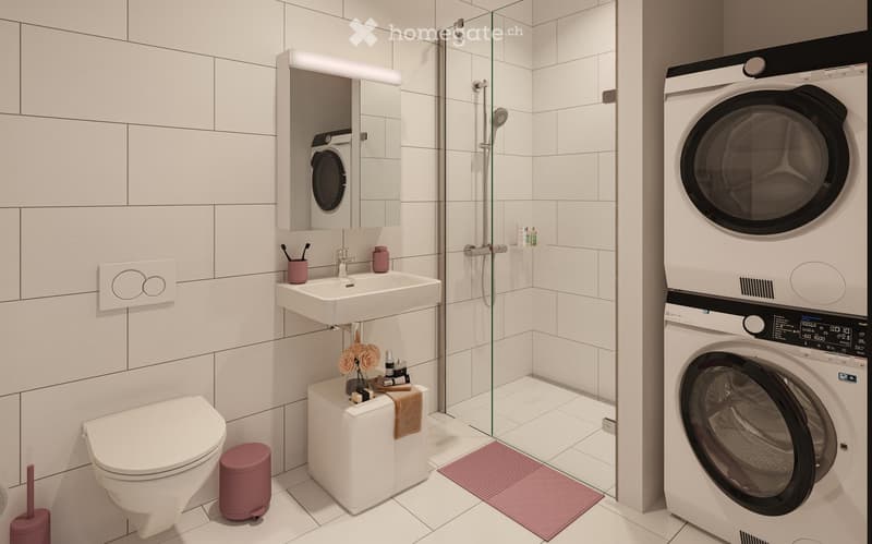 Modern bathroom with white tiles, a toilet, a sink with a mirror, a shower with a glass enclosure, a washing machine, and decorative items including a flower vase and a towel.