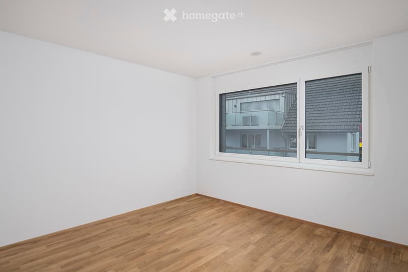 empty room, white walls, wooden floor, large window with balcony view