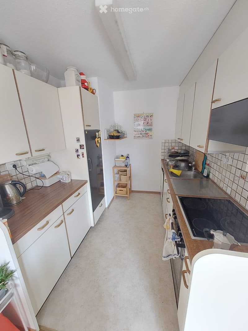 white cabinets, wooden countertops, stainless steel appliances, tiled backsplash, white refrigerator, white microwave, white oven, white dishwasher, white washing machine, white sink, white faucet, white floor