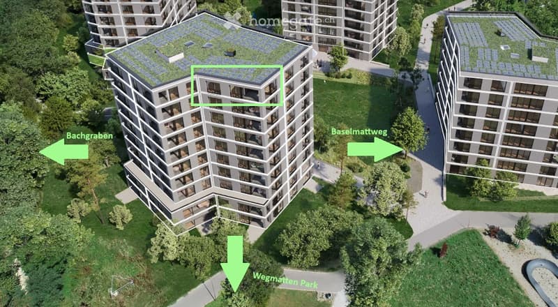 Aerial view of a modern multi-story residential building with green rooftop, surrounded by greenery and pathways.