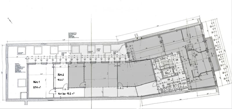 Floor plan of a residential building showing multiple rooms including offices, living spaces, and outdoor areas.