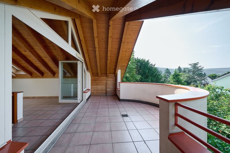 Balcony with wooden ceiling, tiled floor, glass door, and scenic view of greenery and hills.