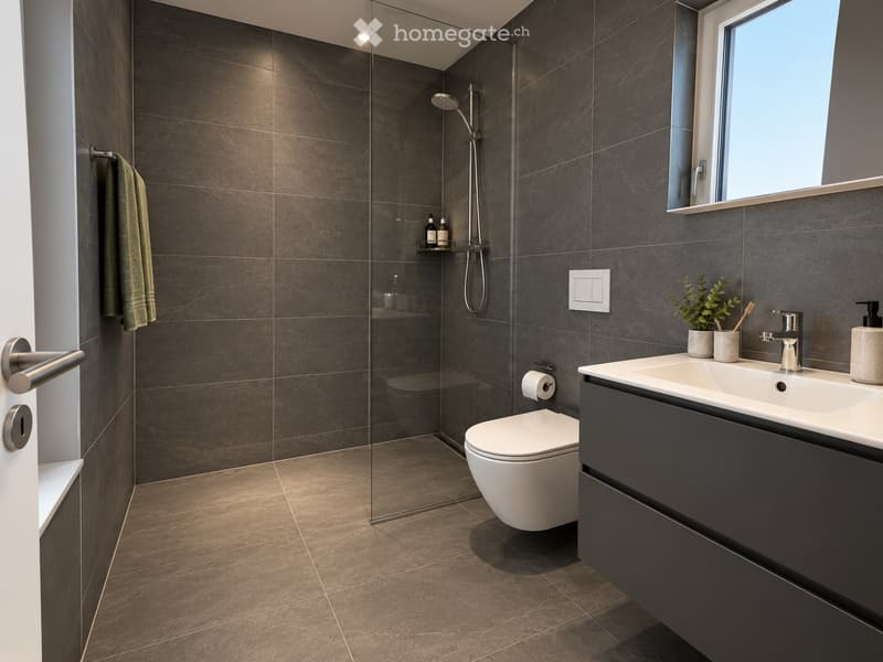 Modern bathroom with dark tiled walls and floor, featuring a glass-enclosed shower, a white toilet, a sink with a modern faucet, and a towel on the wall.
