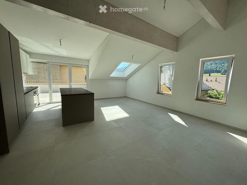 Empty room with light green walls, tiled floor, skylight, and large windows. Minimalist design with no furniture.