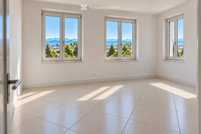 Empty room with white walls, tiled floor, and large windows offering a scenic mountain view.