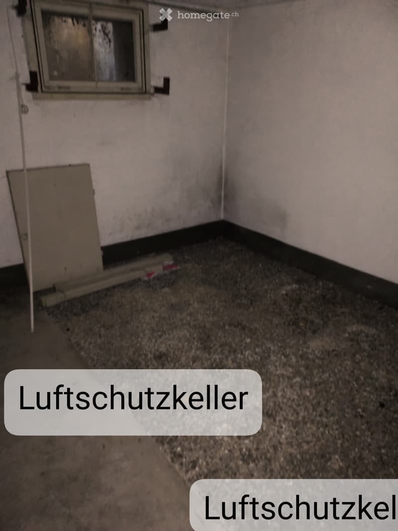 Empty room with bare walls, a single window, and a concrete floor. No furniture or equipment is present.