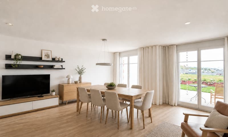Bright, modern living and dining area with wooden flooring, large windows, and a view of the outdoors. Features a dining table with chairs, a TV on a cabinet, shelves with decorative items, and a hanging pendant light.