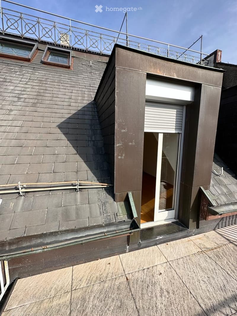 Roof with an attic entrance and balcony