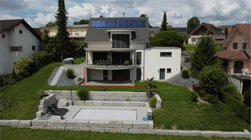 Modern two-story house with solar panels, garage, swimming pool, and well-maintained garden.