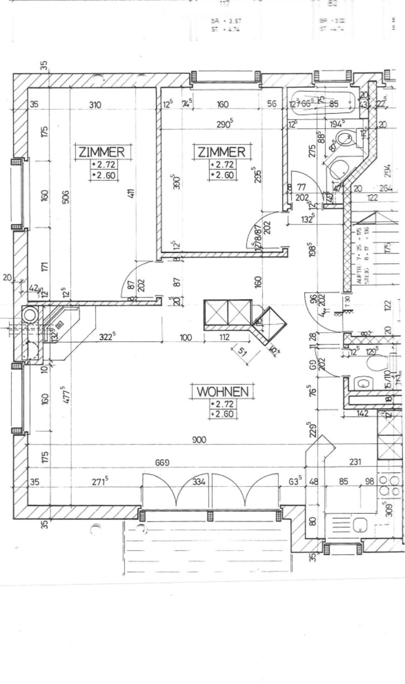 Floor plan showing a multi-room layout with labeled dimensions and room names including "ZIMMER" and "WOHNEN".
