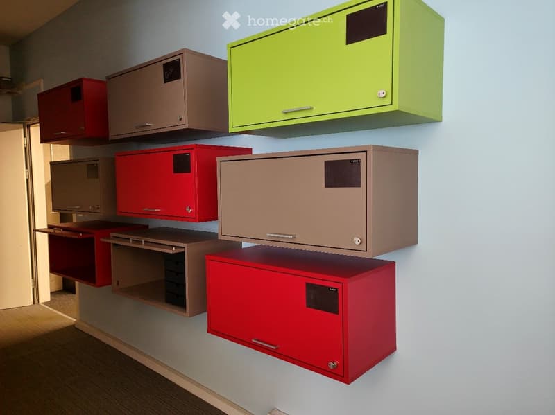 A room with multiple wall-mounted cabinets and shelves in various colors, including red, brown, and green, arranged neatly on light blue walls.