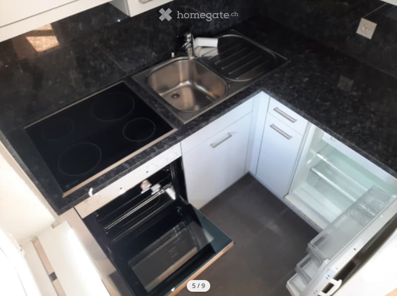 a gas hob, oven, double stainless steel sink, refrigerator, dishwasher, granite countertop