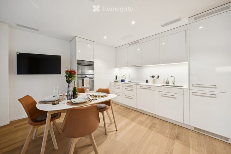 {"type": "Furnished Room", "objects": ["dining table", "chair", "bottle", "vase", "faucet", "sink", "oven", "cup", "faucet", "bottle", "faucet", "faucet", "bottle", "bottle", "bottle", "bottle", "bottle", "bottle", "bottle", "bottle", "bottle", "bottle",