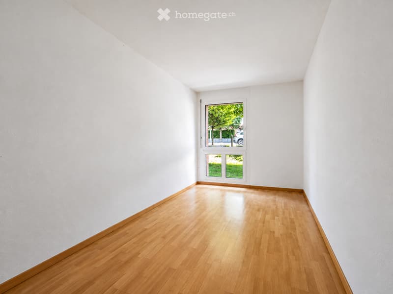 Completely empty room with bare white walls and wooden floor. No furniture or equipment.