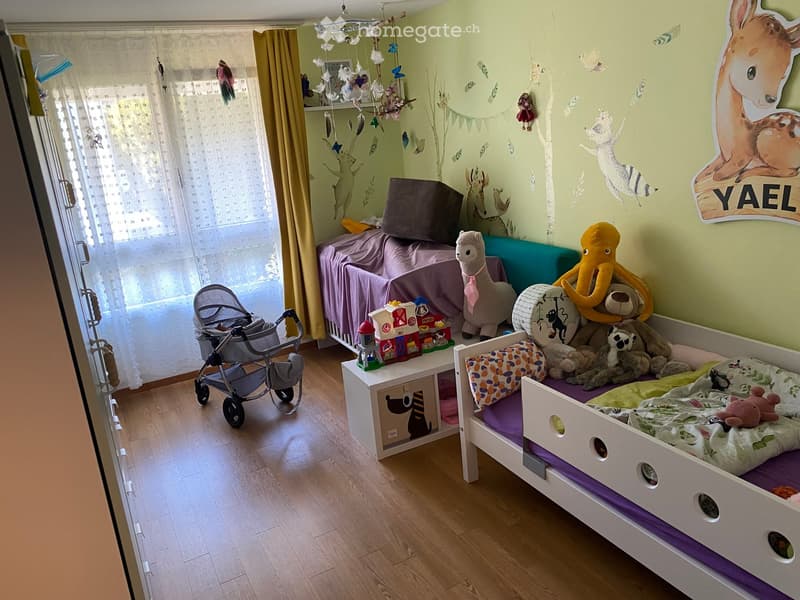 Brightly colored children's bedroom with a bunk bed, stuffed animals, toys, and a baby stroller near the window.