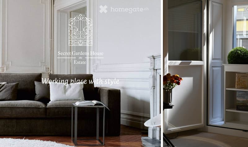 A stylish living room with a grey sofa, small table, bookshelf, and decorative vase with flowers. Large windows and elegant wall moldings.