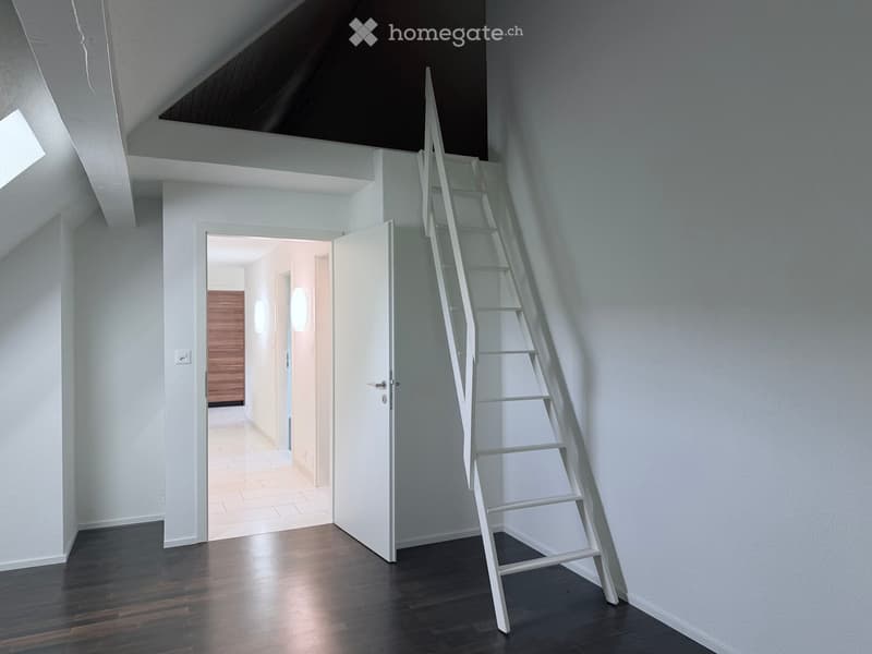 A modern, minimalist hallway with a sleek white staircase, dark wooden flooring, and white walls. An open doorway leads to another room with warm lighting and wooden paneling.