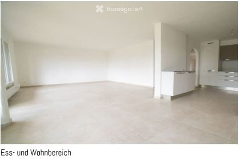 Completely empty room with white walls, large windows, and a tiled floor. No furniture or equipment.