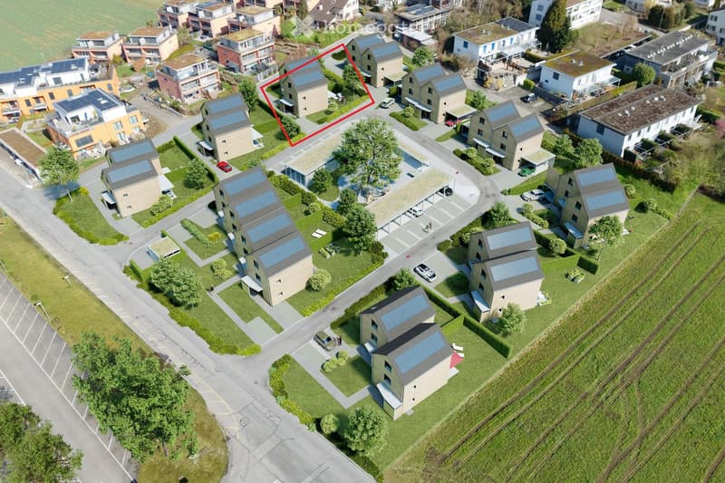 Aerial view of a residential neighborhood with multiple houses, solar panels on rooftops, driveways, and parked cars.
