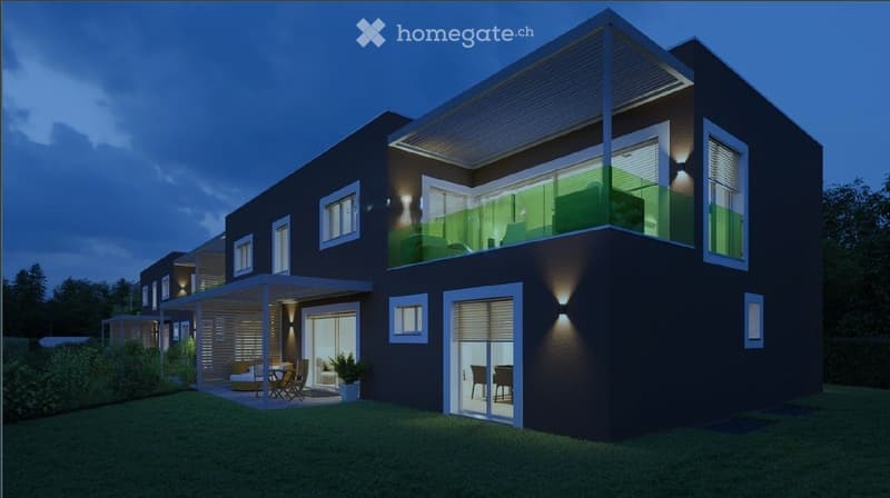 Modern two-story house with dark exterior, large windows, and a balcony on the upper level. The ground floor features a covered patio area with outdoor furniture.