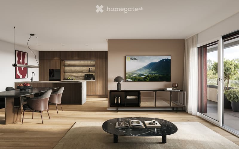 Modern open-plan kitchen and dining area with wooden flooring, dark wooden cabinets, a central island, and a dining table with chairs. Features include a large TV screen, pendant lights, a coffee table with books and a cup, and a potted plant near the win