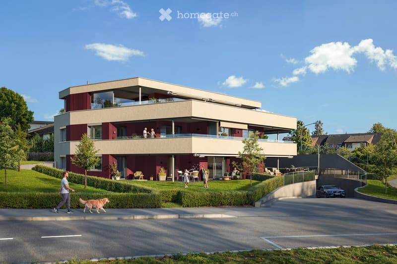 Modern two-story house with red and beige facade, large windows, balconies, and a well-maintained garden area.