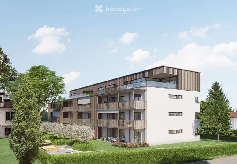 Modern multi-story residential building with balconies, large windows, and a landscaped garden area with seating and plants.
