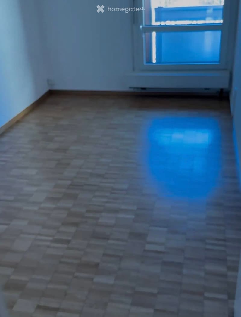 Empty room with tiled floor and a window at the far end, no furniture or equipment visible.