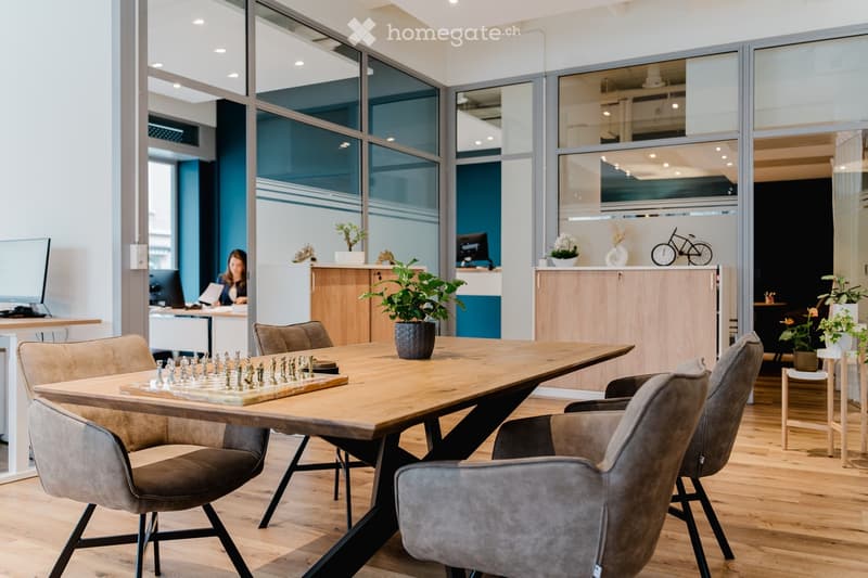 glass walls, chess board, wooden table, wooden floor, office chairs, office desks, plants