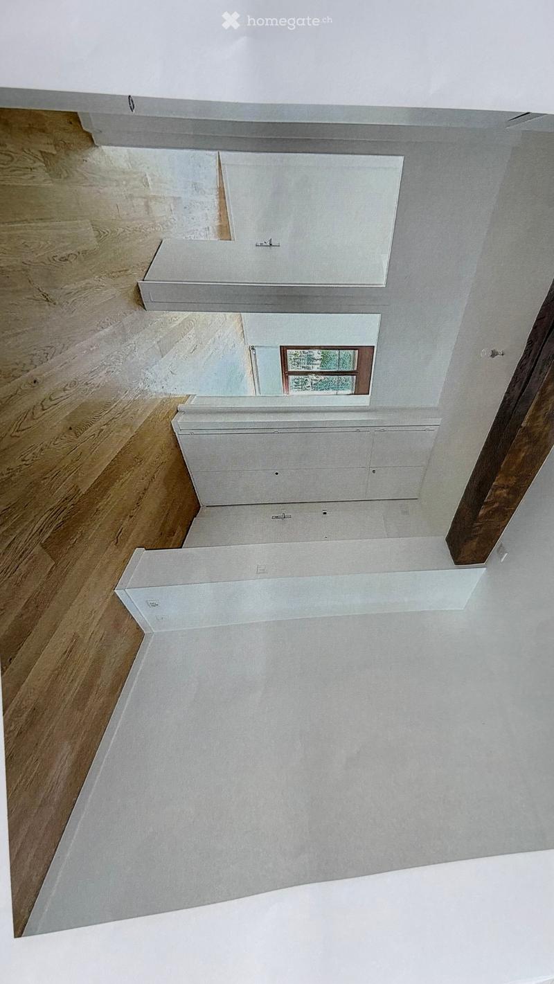 Completely empty room with wooden flooring and white walls. No furniture or equipment visible.