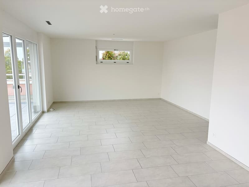 Empty room with white walls, tiled floor, large sliding glass door, and a small window above.