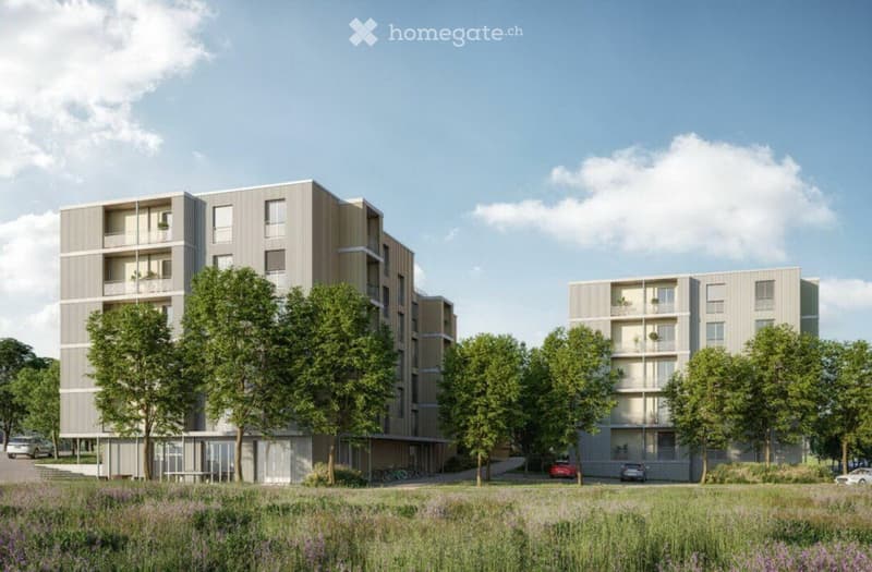 Modern multi-story residential building with balconies, surrounded by trees and a grassy area with parked cars.