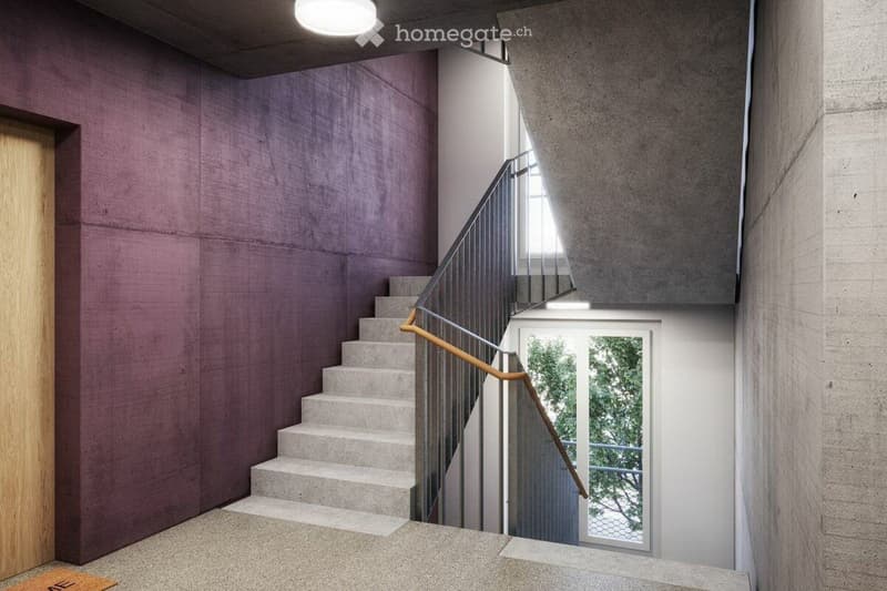 Modern hallway with a staircase featuring concrete steps and a metal railing, illuminated by natural light from a window at the end.