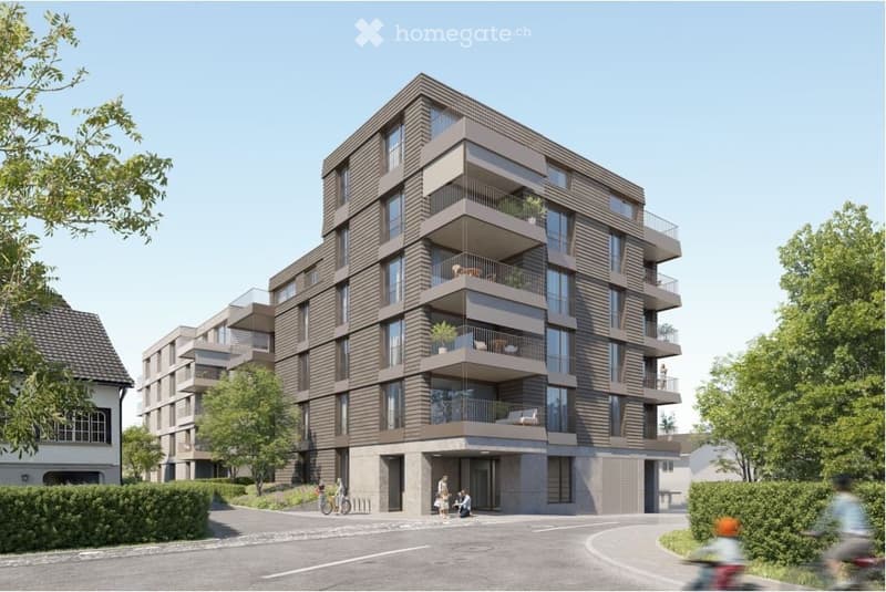 Modern multi-story residential building with balconies, large windows, and contemporary design.