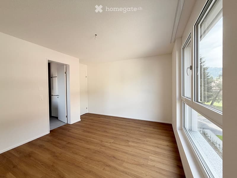 Completely empty room with bare walls and wooden floor. No furniture or equipment.