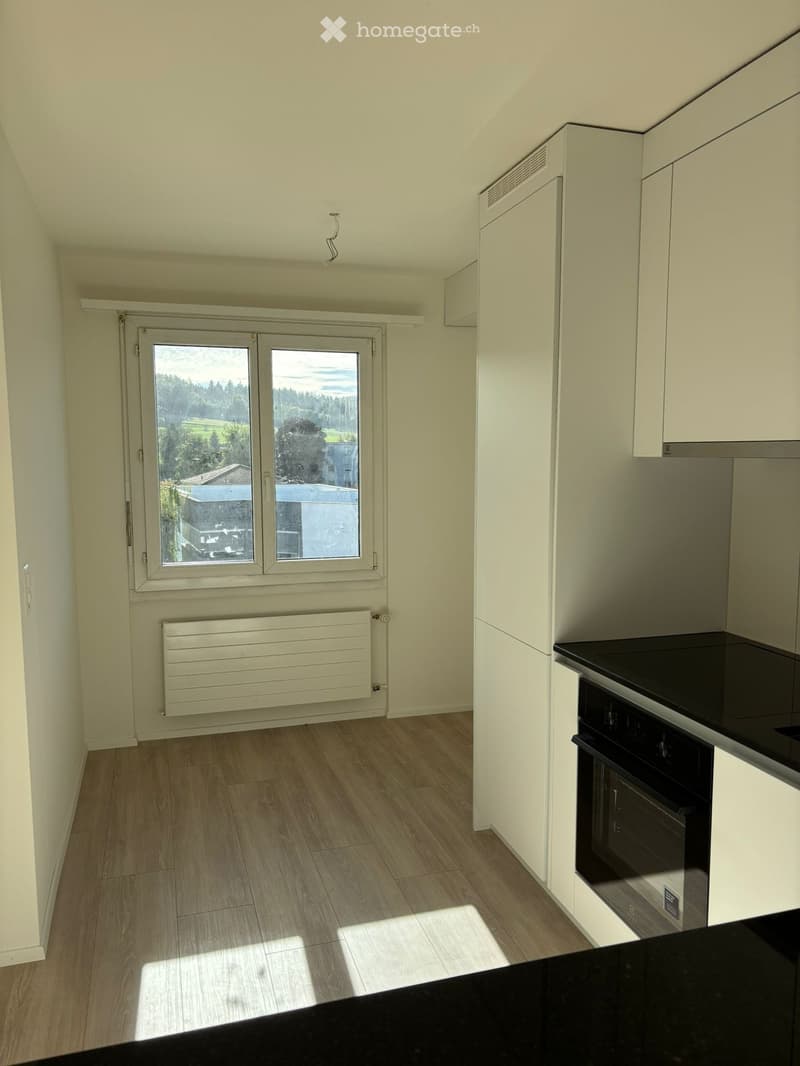 Empty room with large window and bright lighting