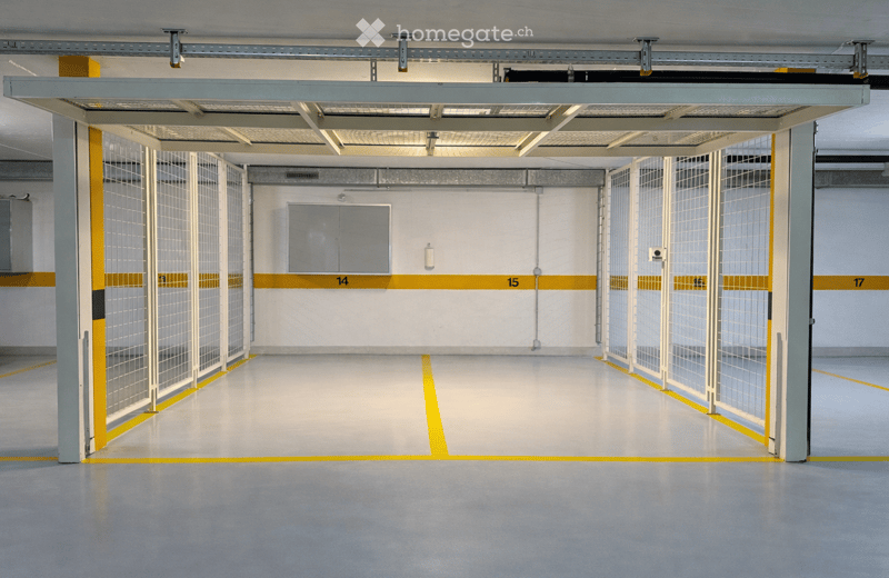 open parking space, three garage doors, yellow lines on floor