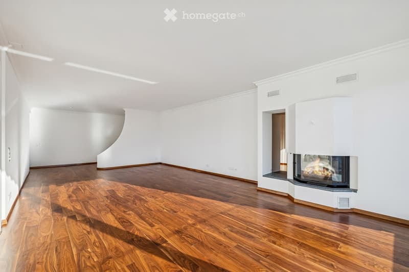 Empty room with hardwood floors, white walls, a fireplace