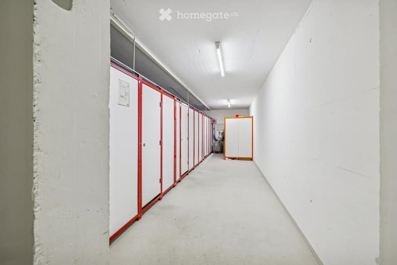 long corridor, rows of storage units, white walls, ceiling lights