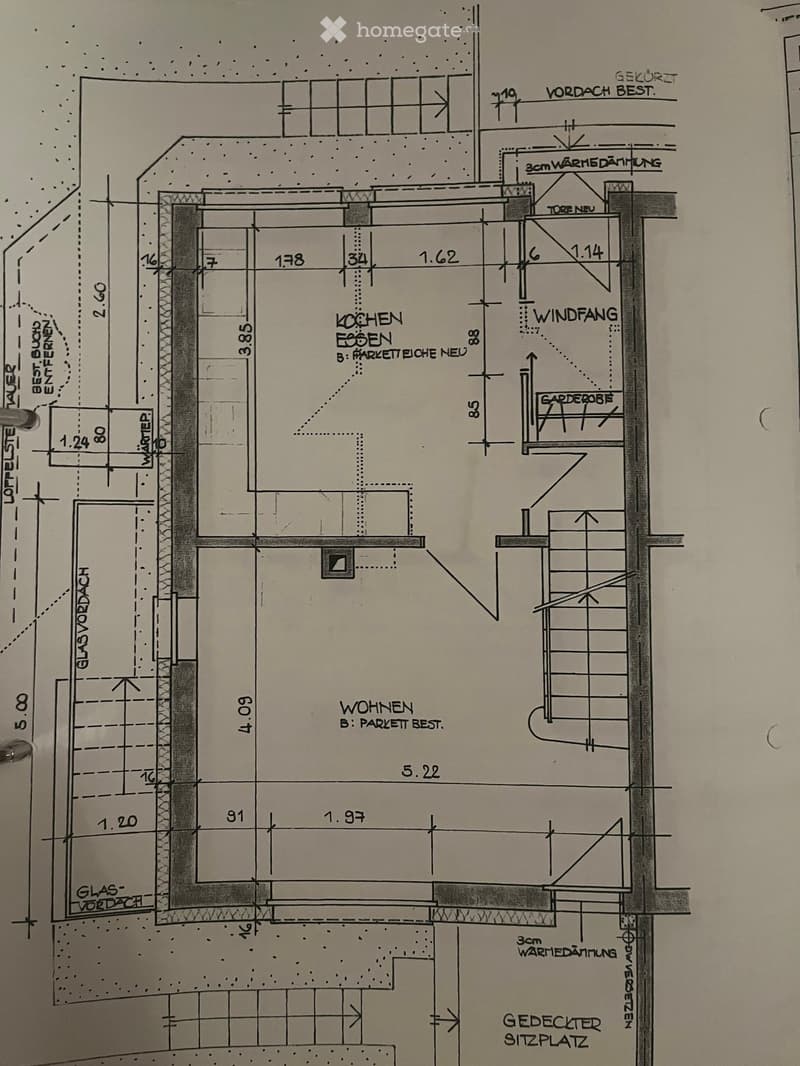 Floor plan showing a kitchen, living area, entrance hall, and covered seating area. Includes measurements and labels for various sections.