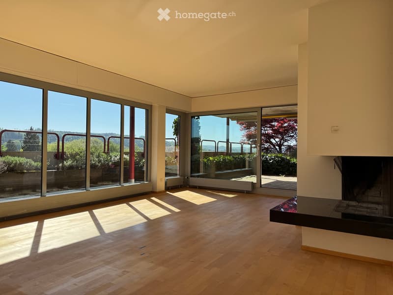 Unfurnished Room. Bright, unfurnished room with large floor-to-ceiling windows, wooden flooring, and a fireplace.