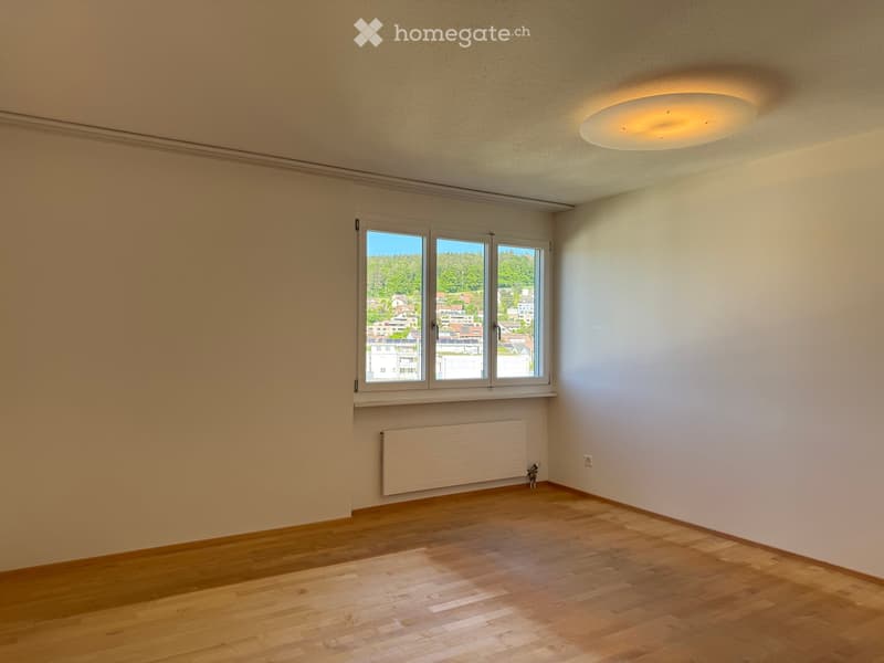 Unfurnished Room. Empty room with wooden flooring, white walls, large window with view, radiator, and ceiling light fixture.