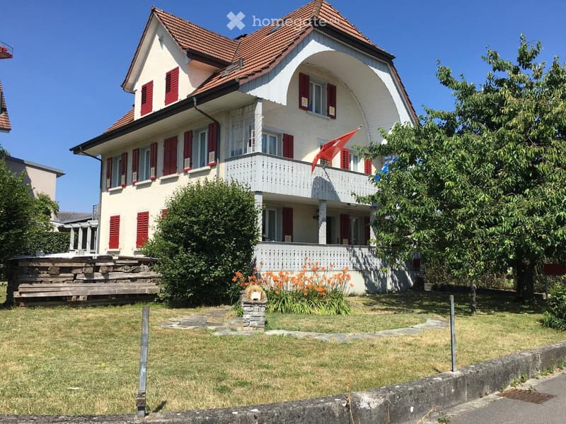 2 story house, white paint, red shutters, brown roof, wooden fence, garden